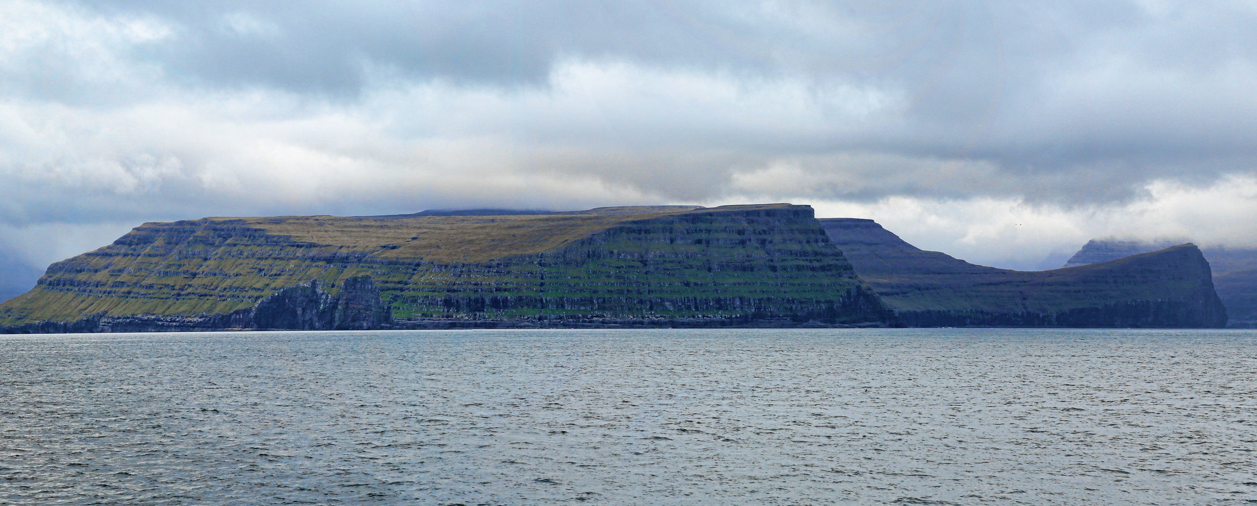 The Faroe Islands are a pile of Paleogene-age basalts, deeply cut by magnificent fjords.