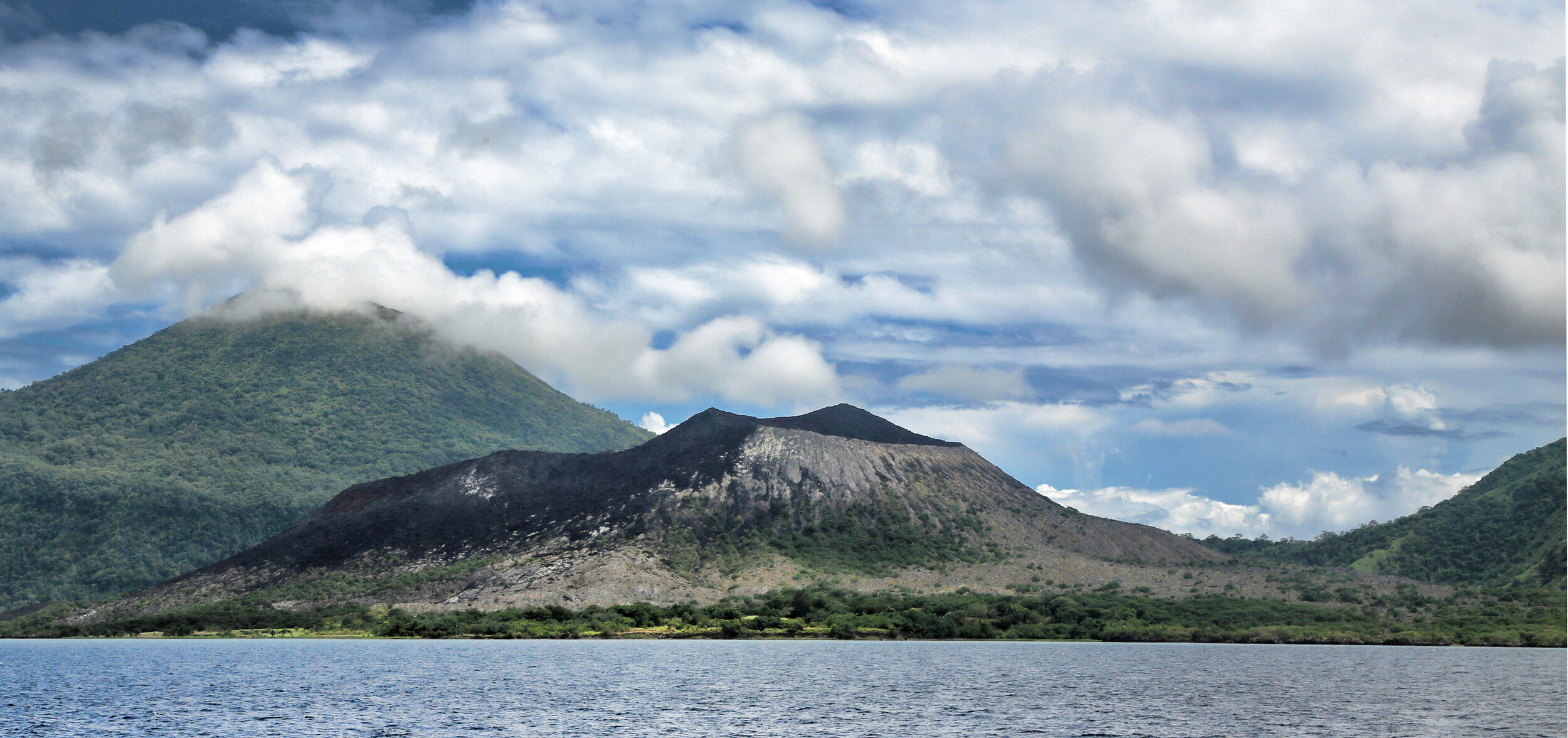 View of Tavurvur from the ship as we enter the harbour within the caldera. This is approximately the same vantage point as that seen in the dramatic video linked below.