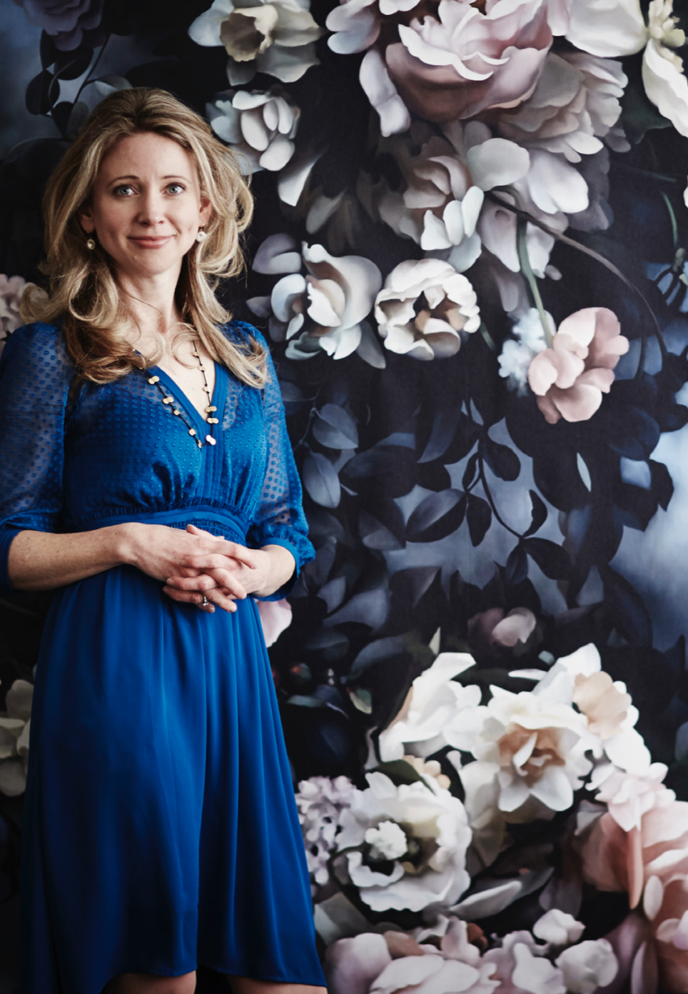 Ellie Cashman stands in front of her Still Life with Shadows Blue wallpaper