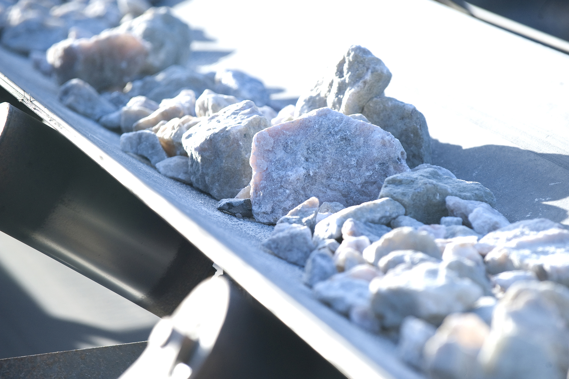 Talison crushed lithium ore on conveyor.jpg