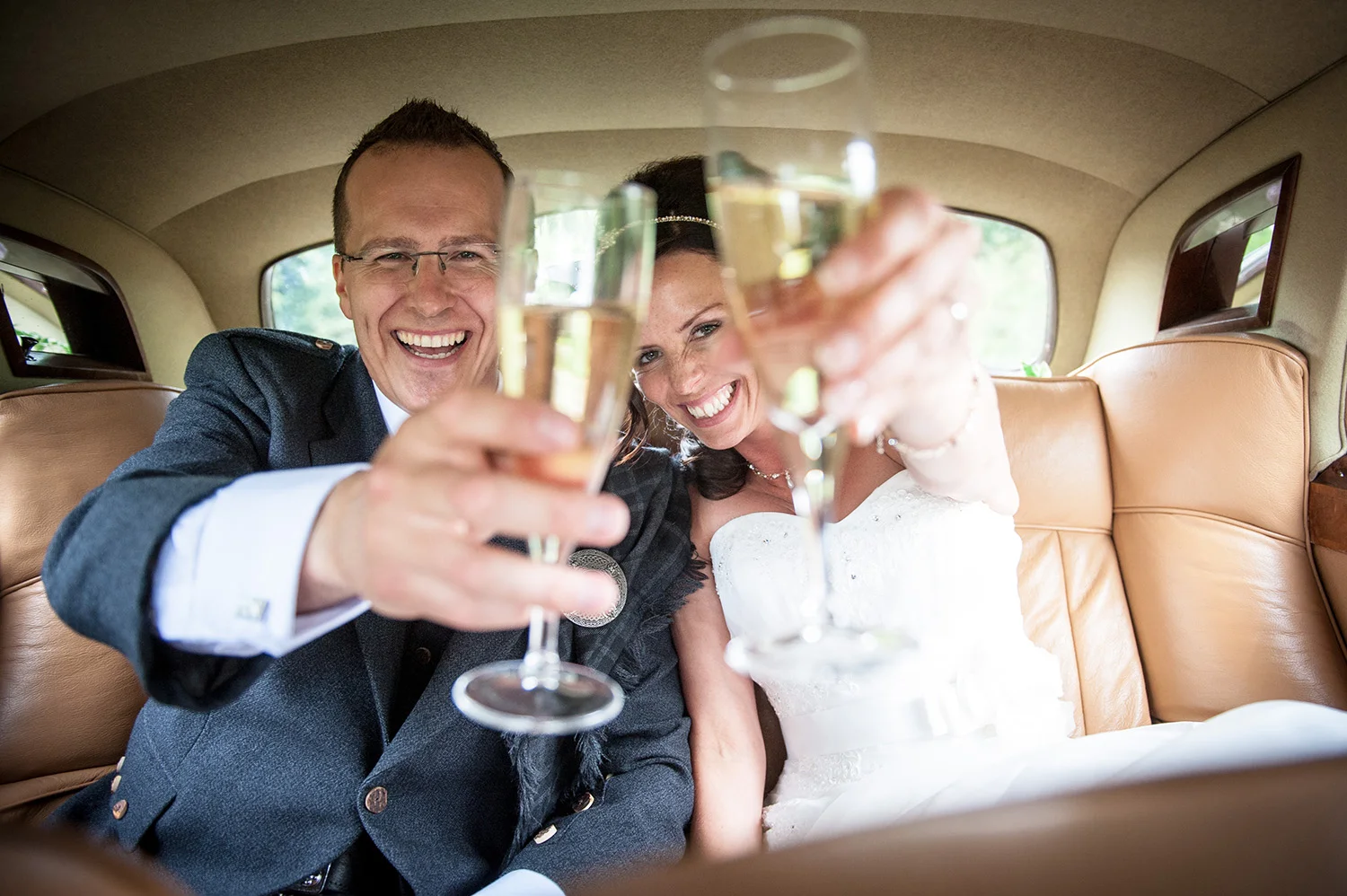 bride-groom-beaming-toasting-champagne.JPG