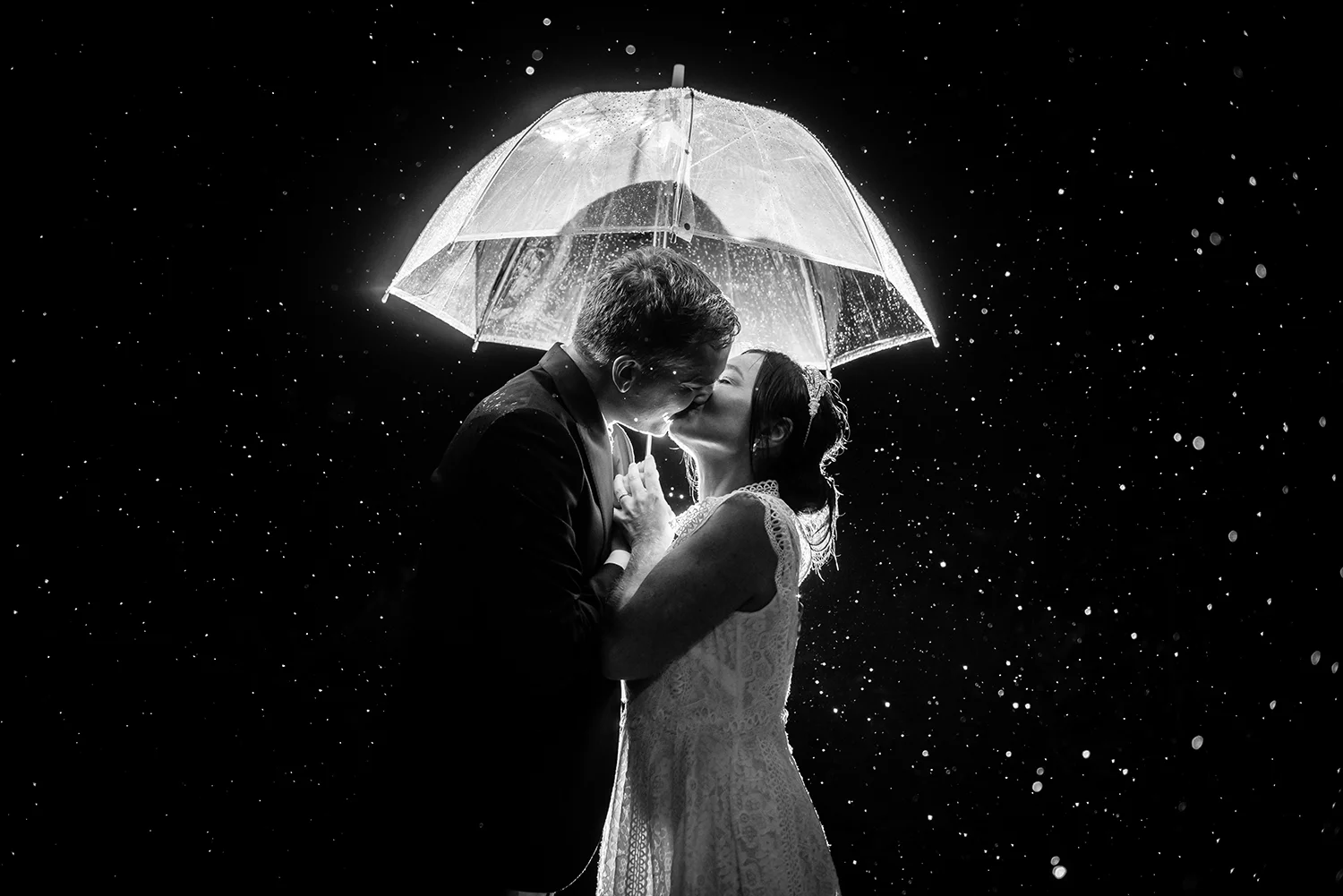 jma-photography-wedding-couple-backlit-kissing-rain.jpg