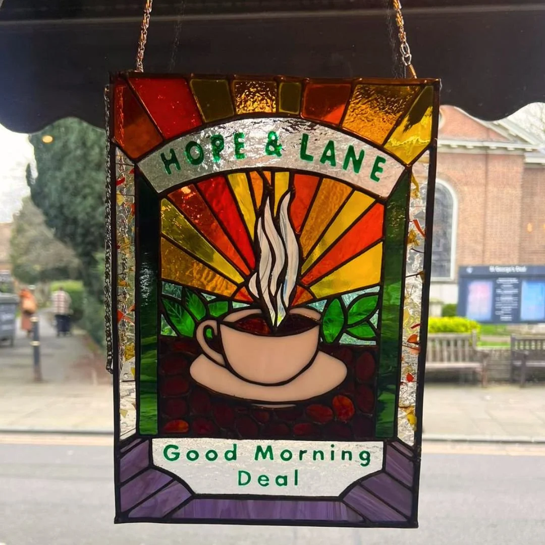 Have you spotted the lovely stained glass sign in our window? 

It was made for us by one of our fantastic regulars, Mark Kelly, who is a dab hand with stained glass.  Thank you Mark. We love it!

@the_glass_mark #thankyou #stainedglass #coffeeshop #