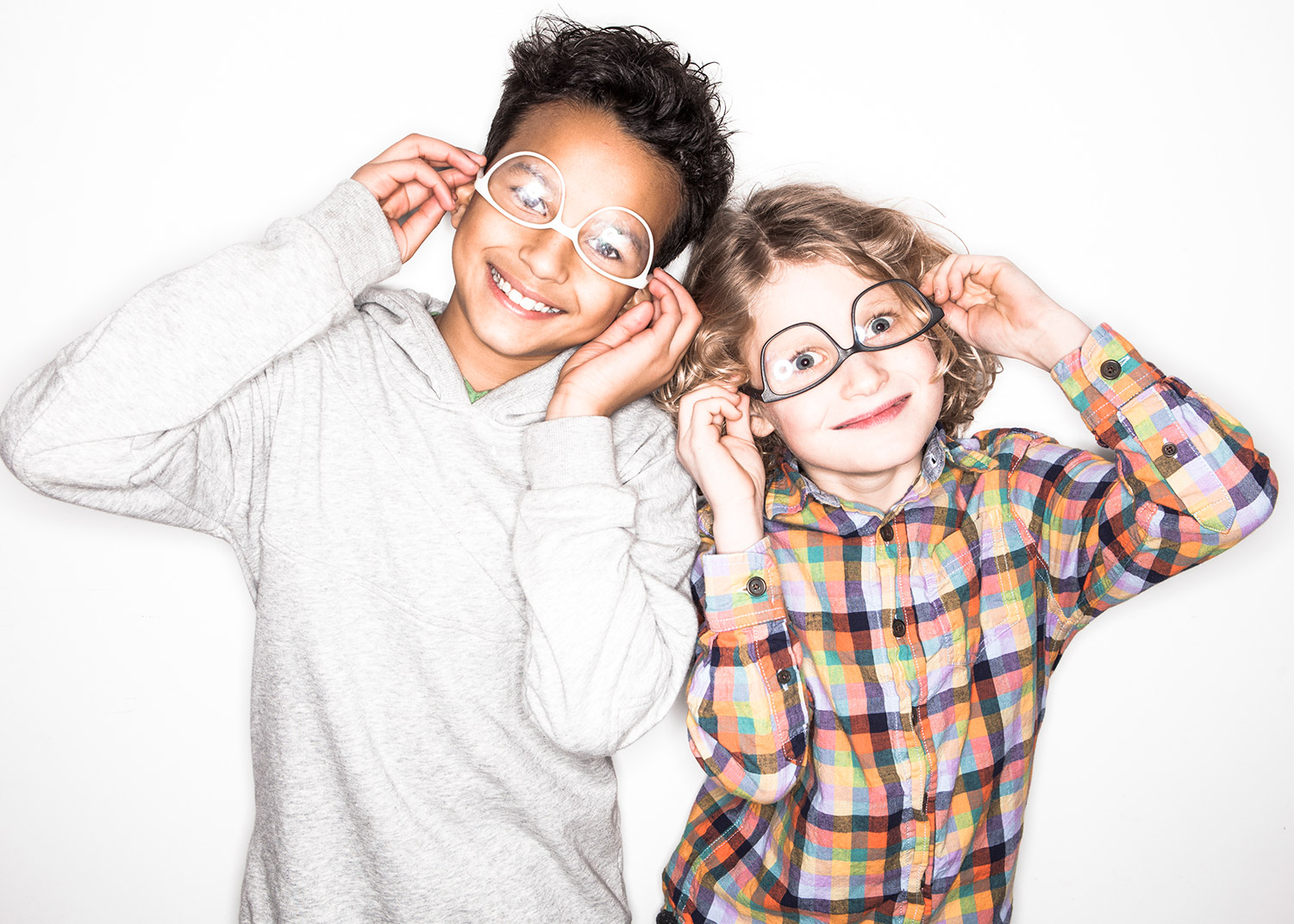 A boy and a girl wearing their 3d Printed glasses upside down