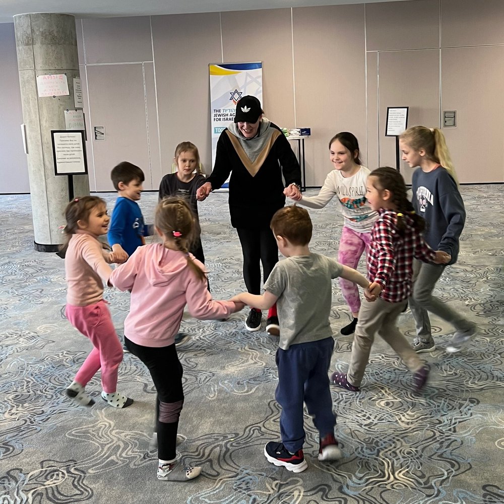 Teaching kids Israeli dancing.