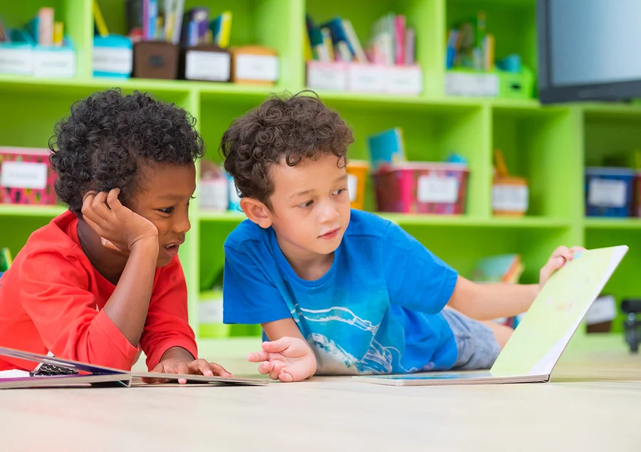 two boys reading a children’s book