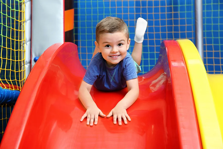 boy sliding down a slide
