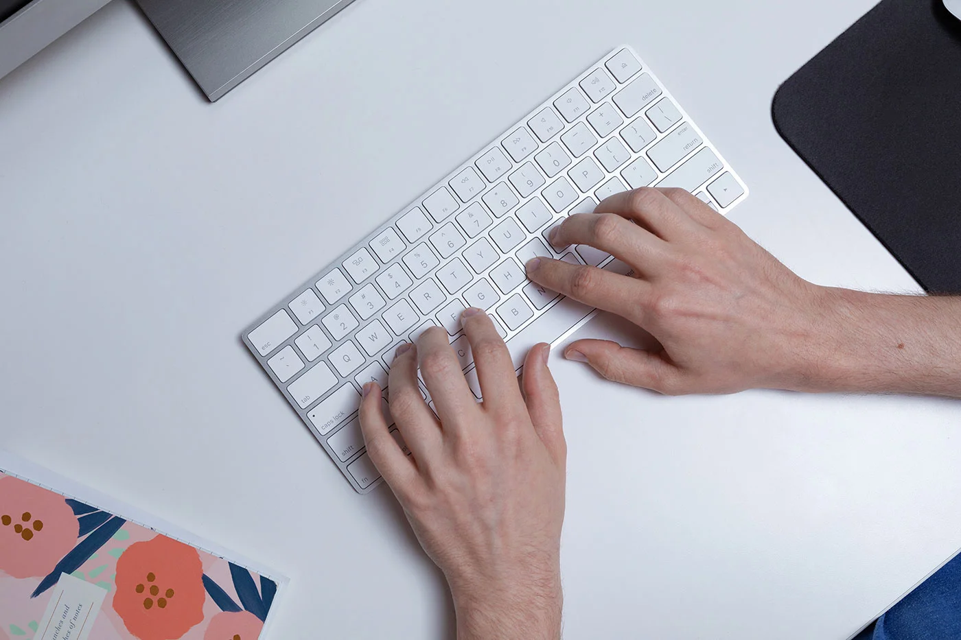 hands typing on keyboard