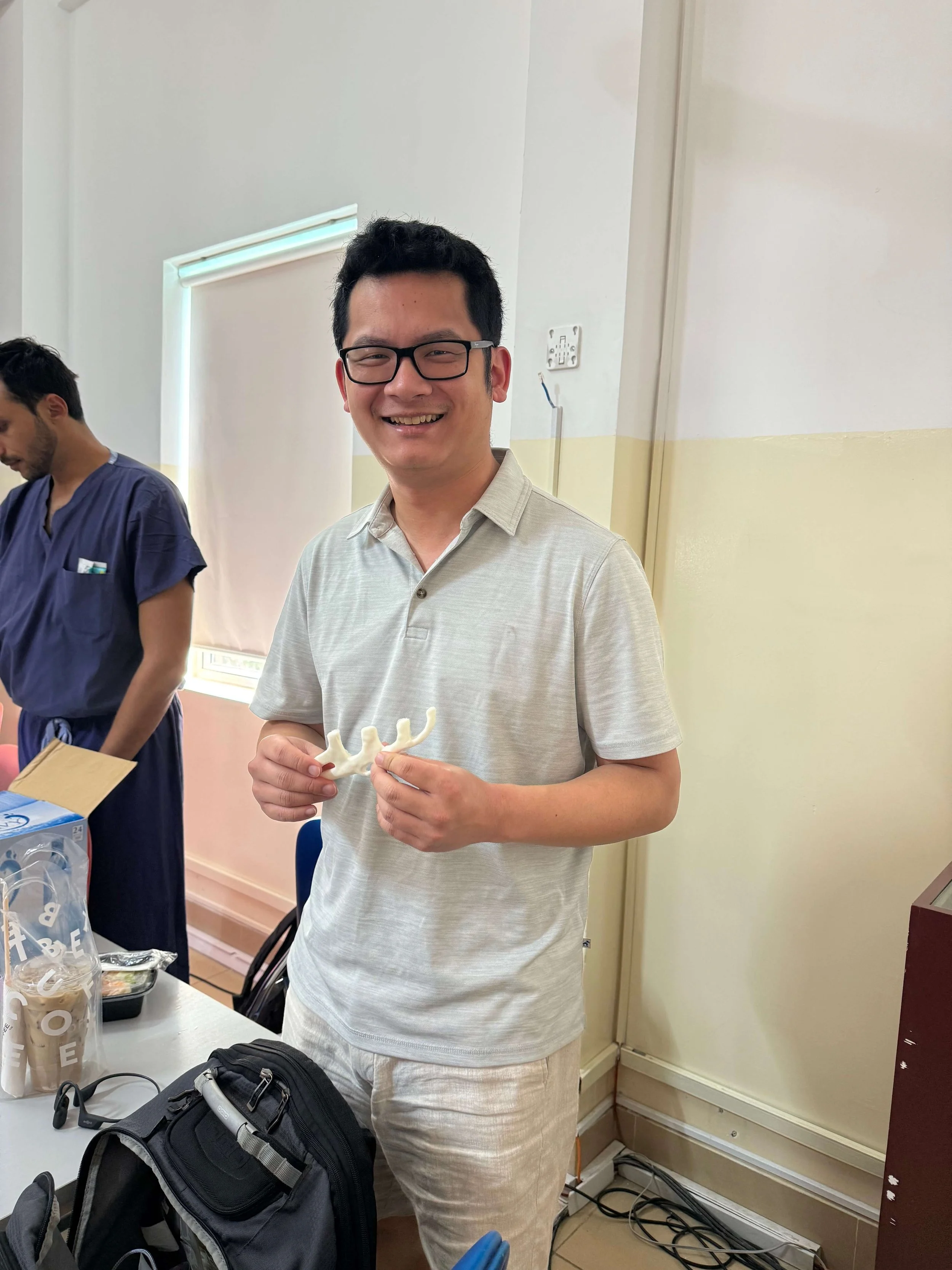 Dr Sheng Zhou displays a synthetic rib model