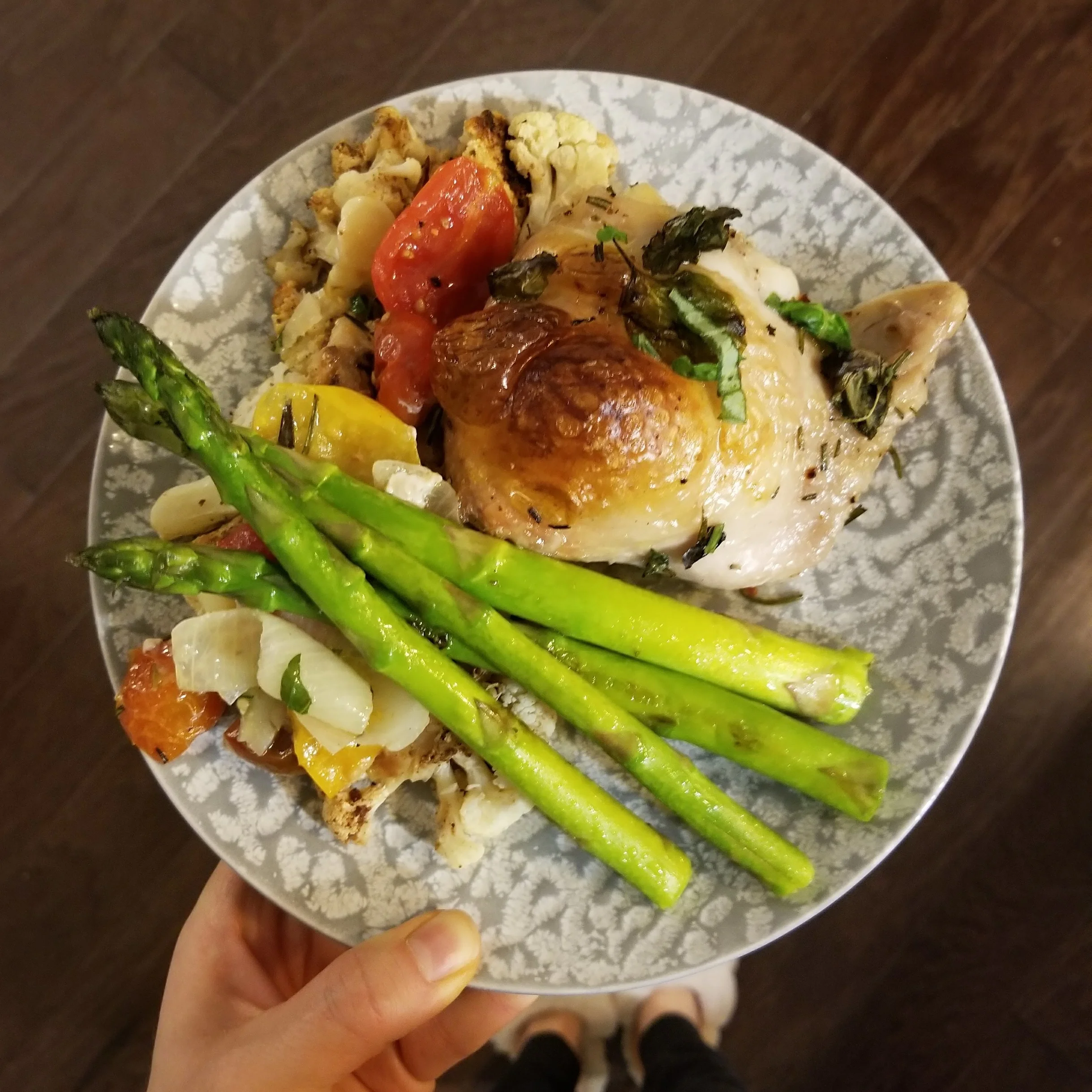 Crispy chicken baked with potatoes, tomatoes and herbs served with sauteed asparagus