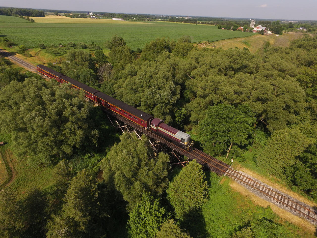 6593 and train drone shot over Conestogo River Treetle  and countryside.jpg