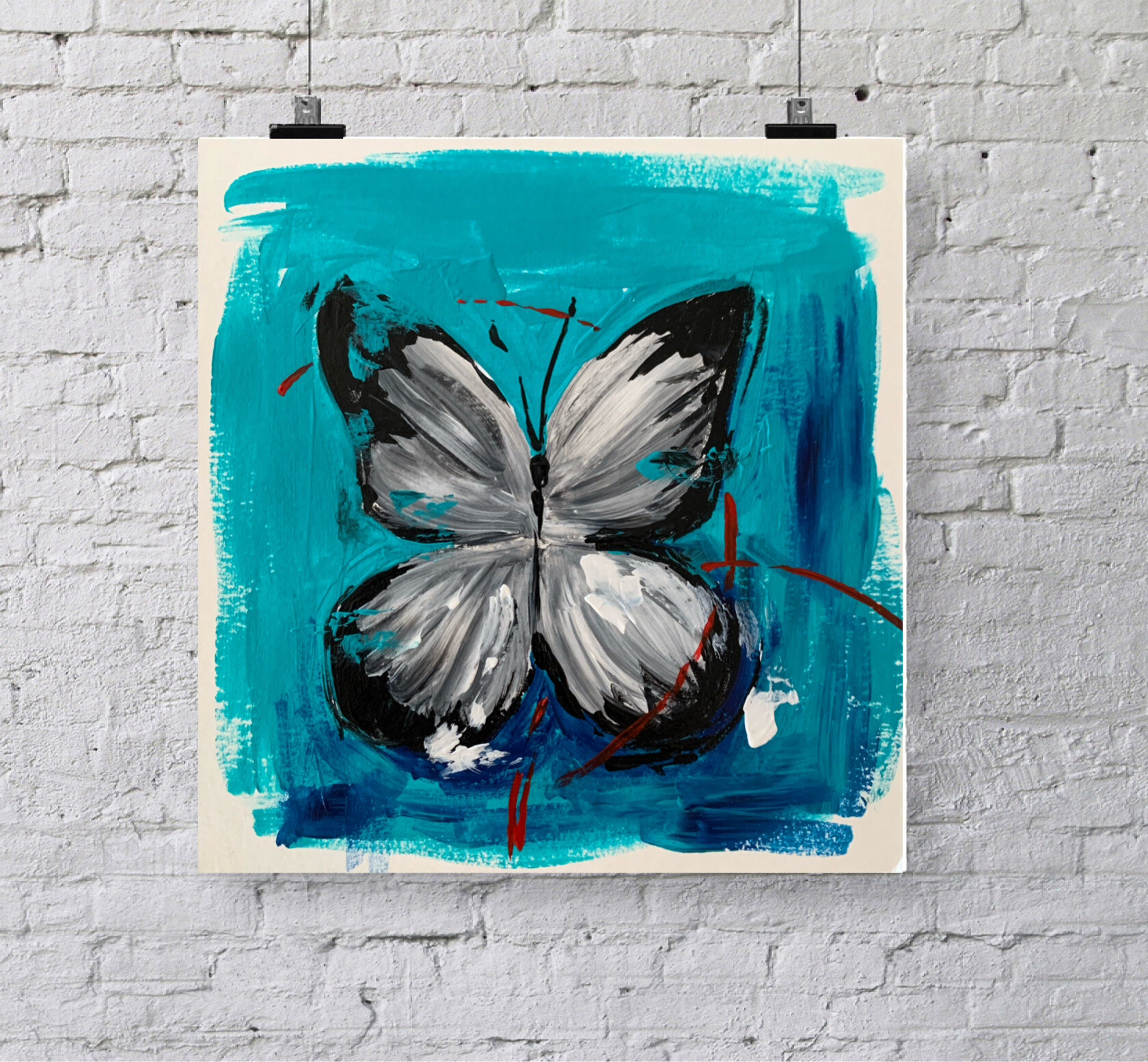 gray and black butterfly on blue background with white bricks