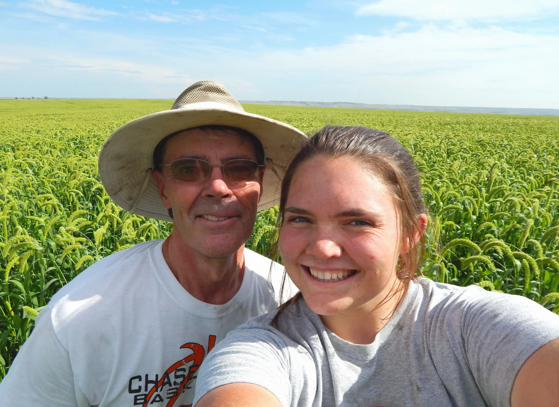 Tom Luhrs and daughter Molly in a field of White Wonder Foxtail Millet.