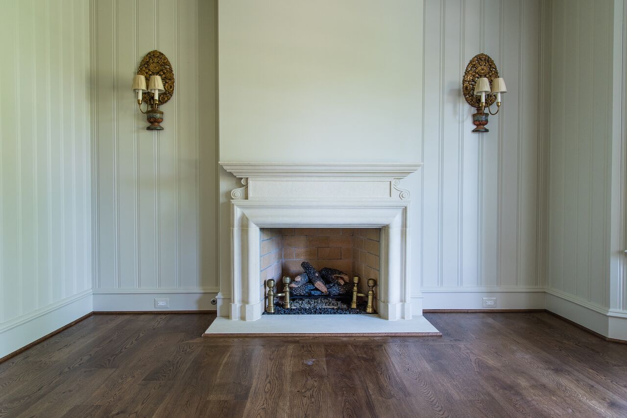 Fireplace surround by Atelier Jouvence Custom Stoneworks in living room of Rutledge model