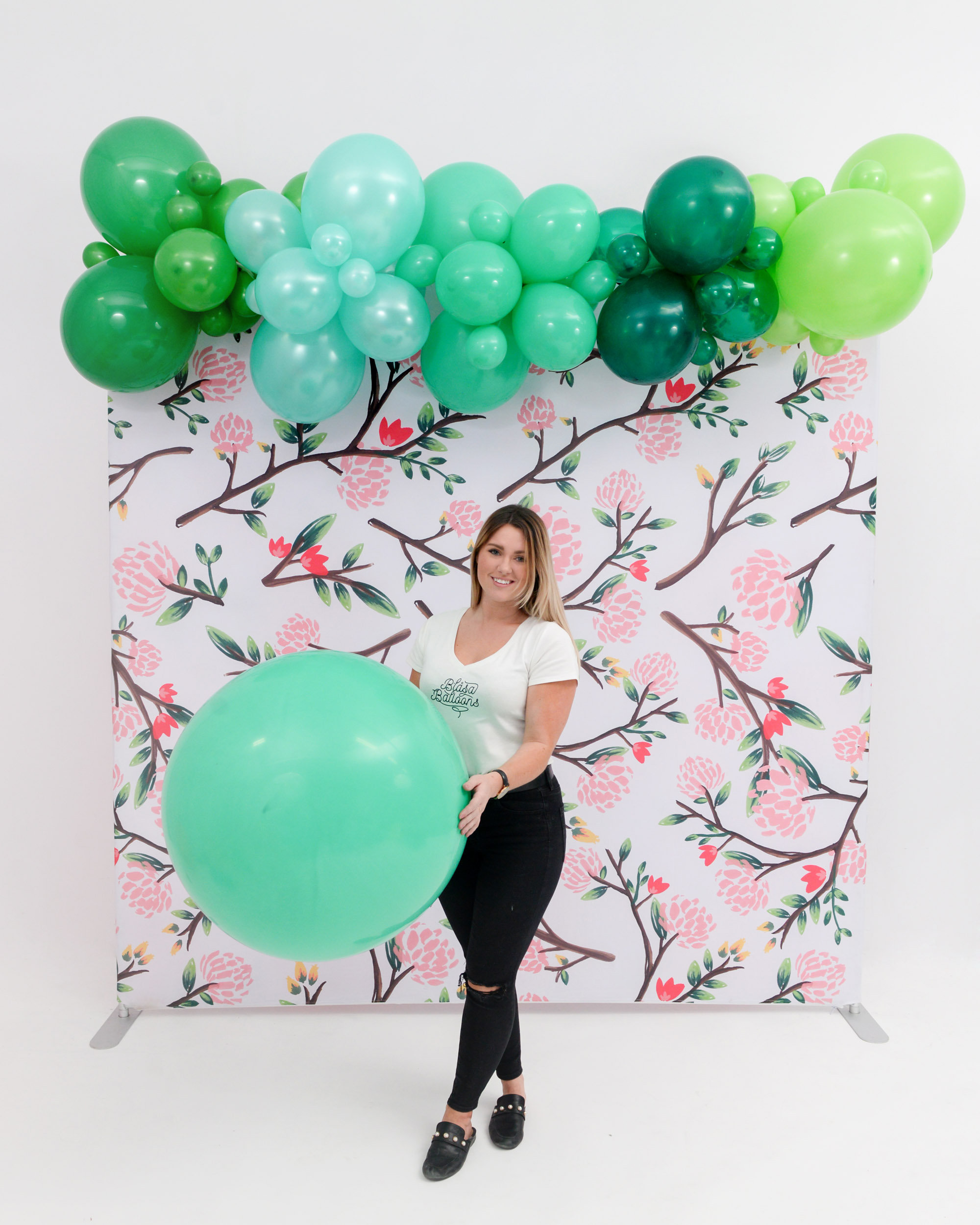 Girl With Green Jumbo Balloon Garland
