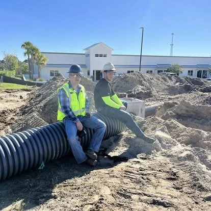Two A&R crew members at commercial job site