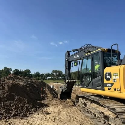 John Deere 210 excavator on site