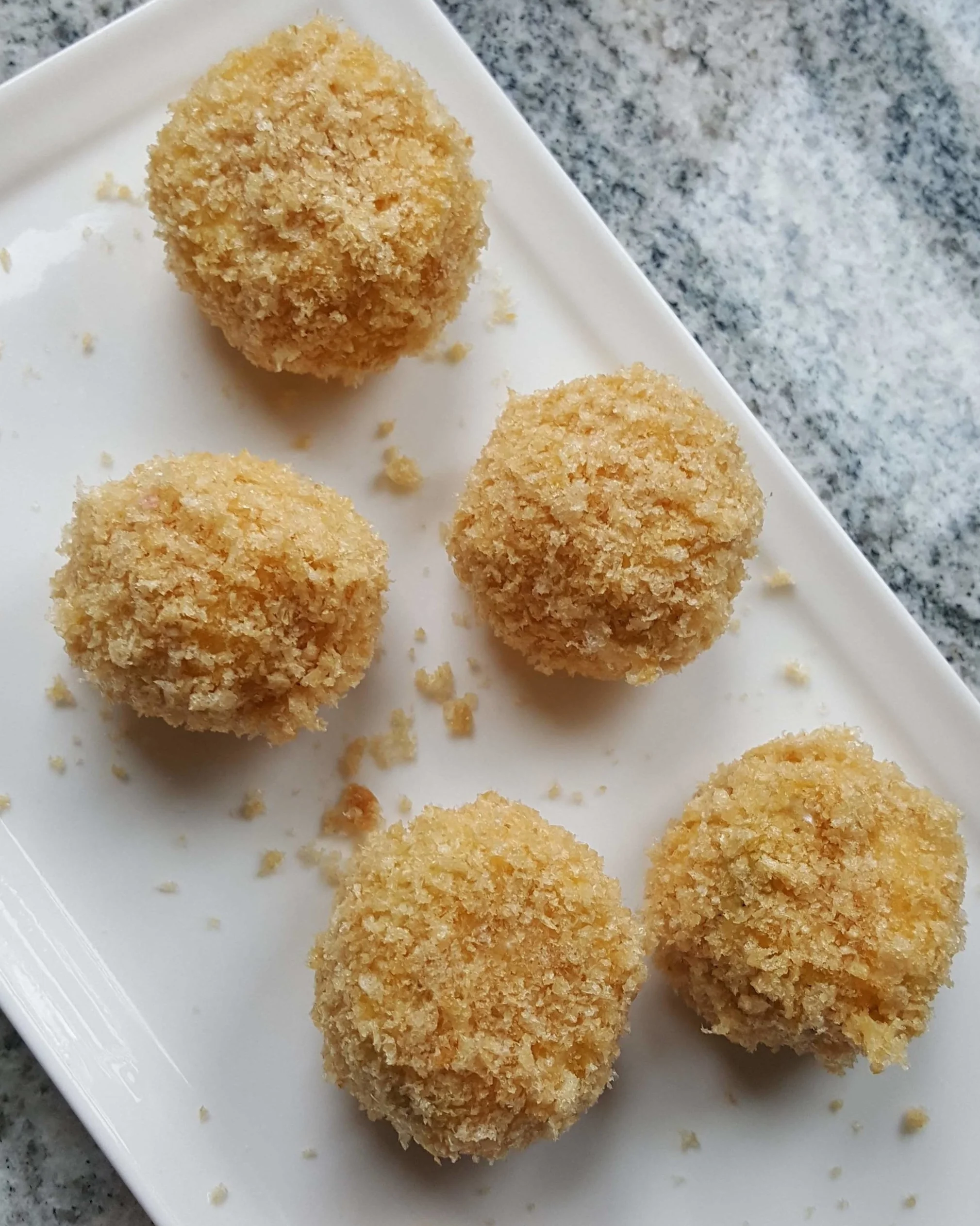 Jalapeño bites after their second coat of pork rinds.