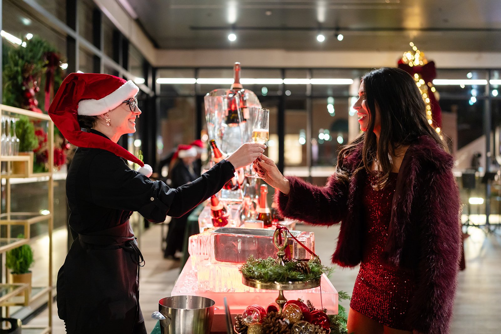 Nicole in Santa hat serving caviar and gelato, planning a holiday party in Park City