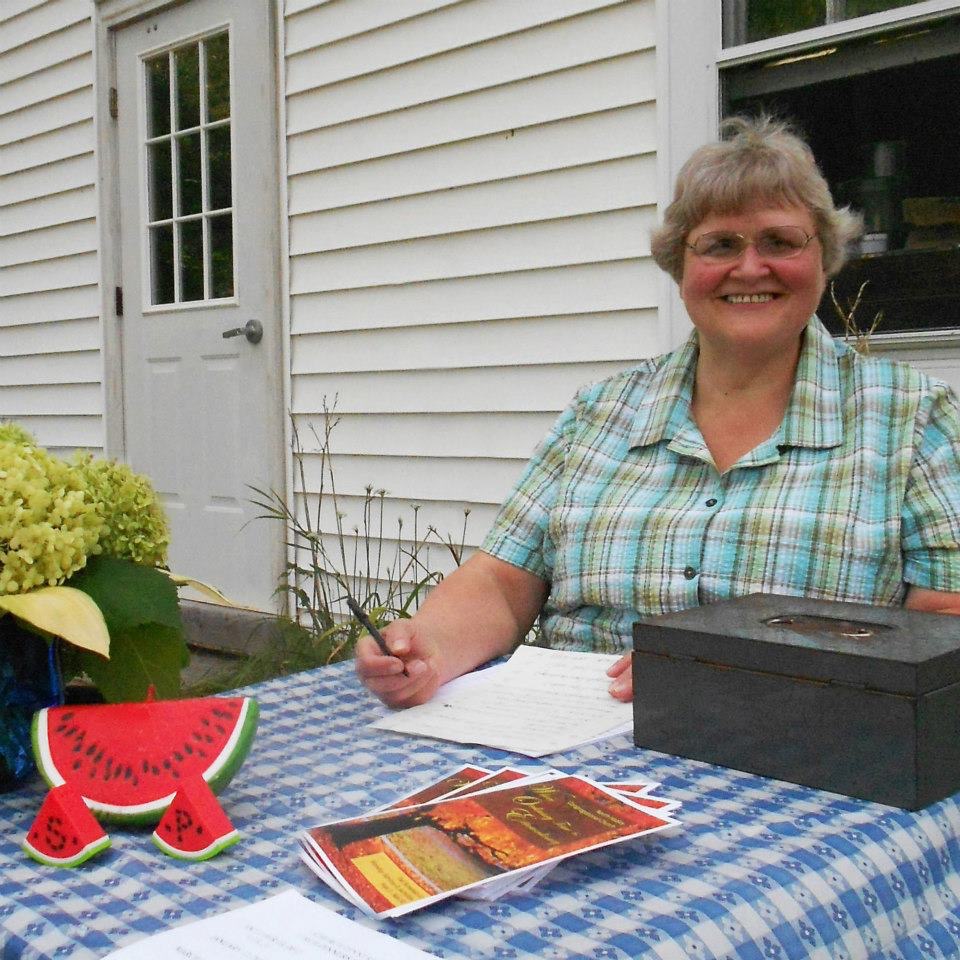 Olga collecting tickets at chicken BBQ.JPG