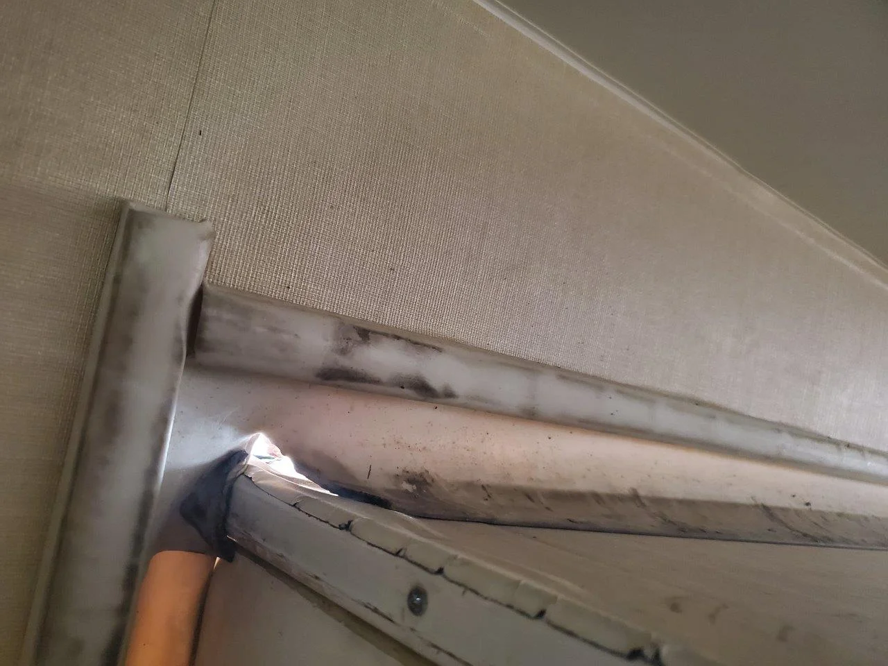 Worn slideout seal with a tear in the corner. This is causing a leak and keeps the slide from extending and retracting smoothly and evenly.