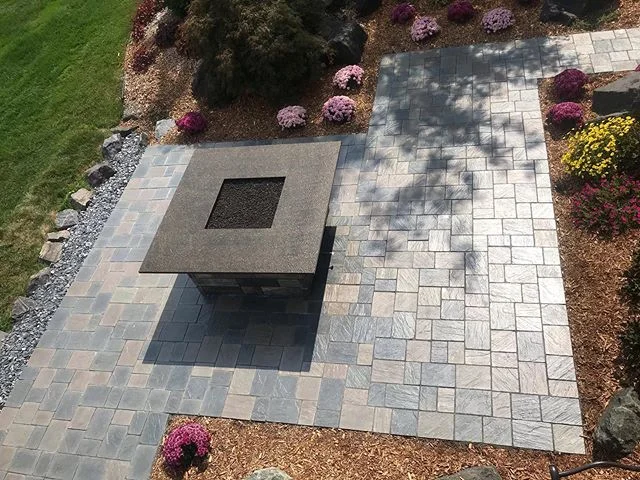 Just finished this patio and fireplace. Both are a Unilock products with a granite top to the fireplace.