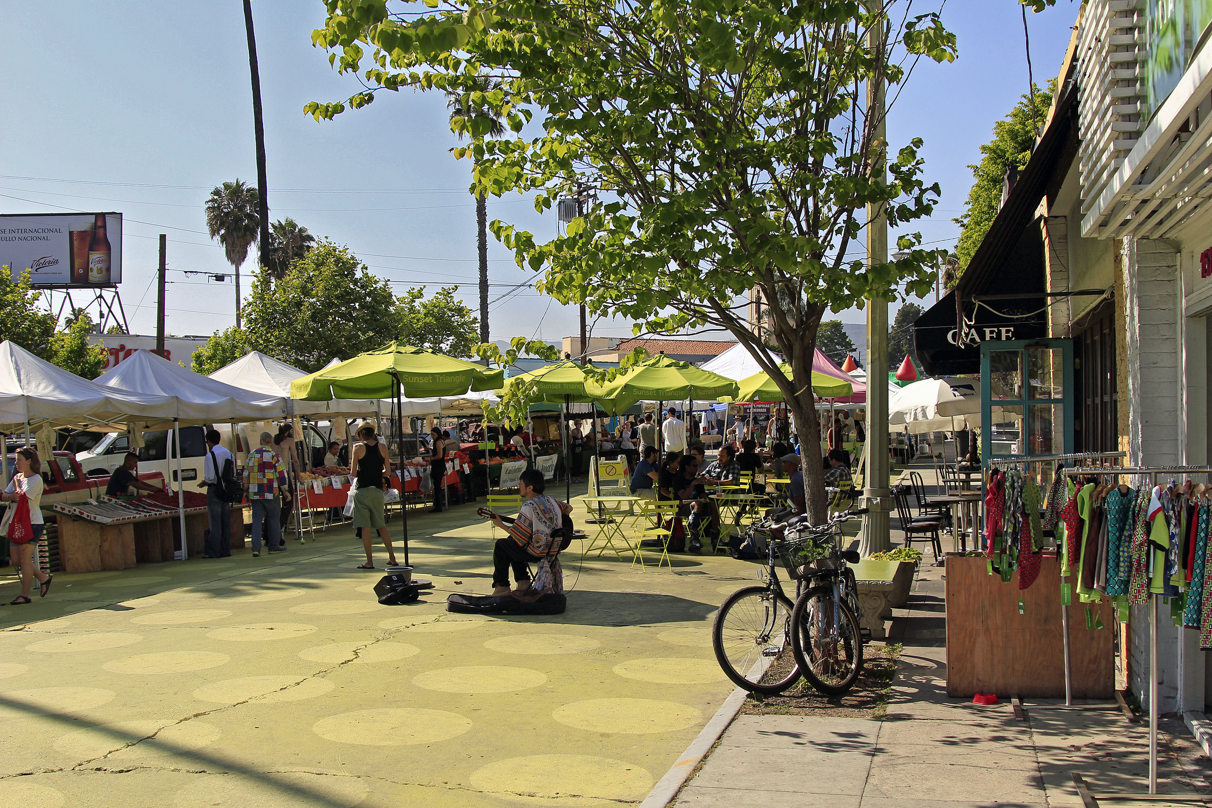 A street performer and vendors at Silver Lake farmers market at Sunset Triangle Park along Sunset Boulevard. Learn more about Silver Lake...