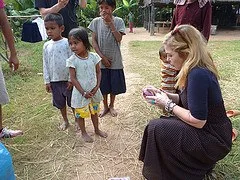 Dr. Suzanne Levine helping the children to try on their new shoes.