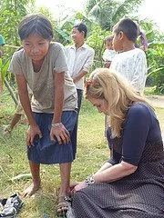 Dr. Suzanne Levine helping a boy to find a pair that will help protect his feet every day.