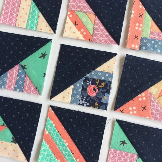 close up of 2%22 foundation paper pieced scrappy triangle quilt blocks.jpg