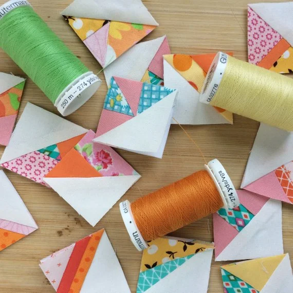 1%22 foundation paper pieced scrappy triangle quilt blocks with spools of thread.jpg
