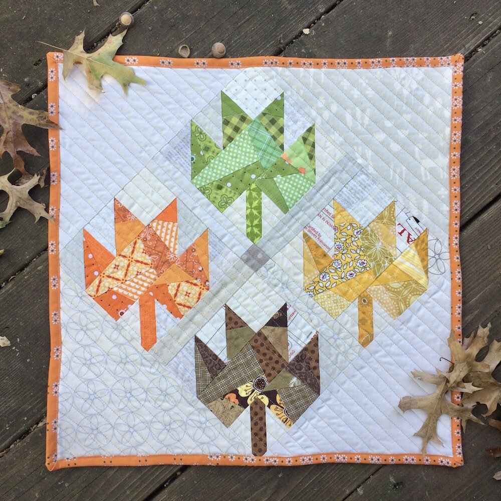 Scrappy maple leaves mini quilt.jpeg