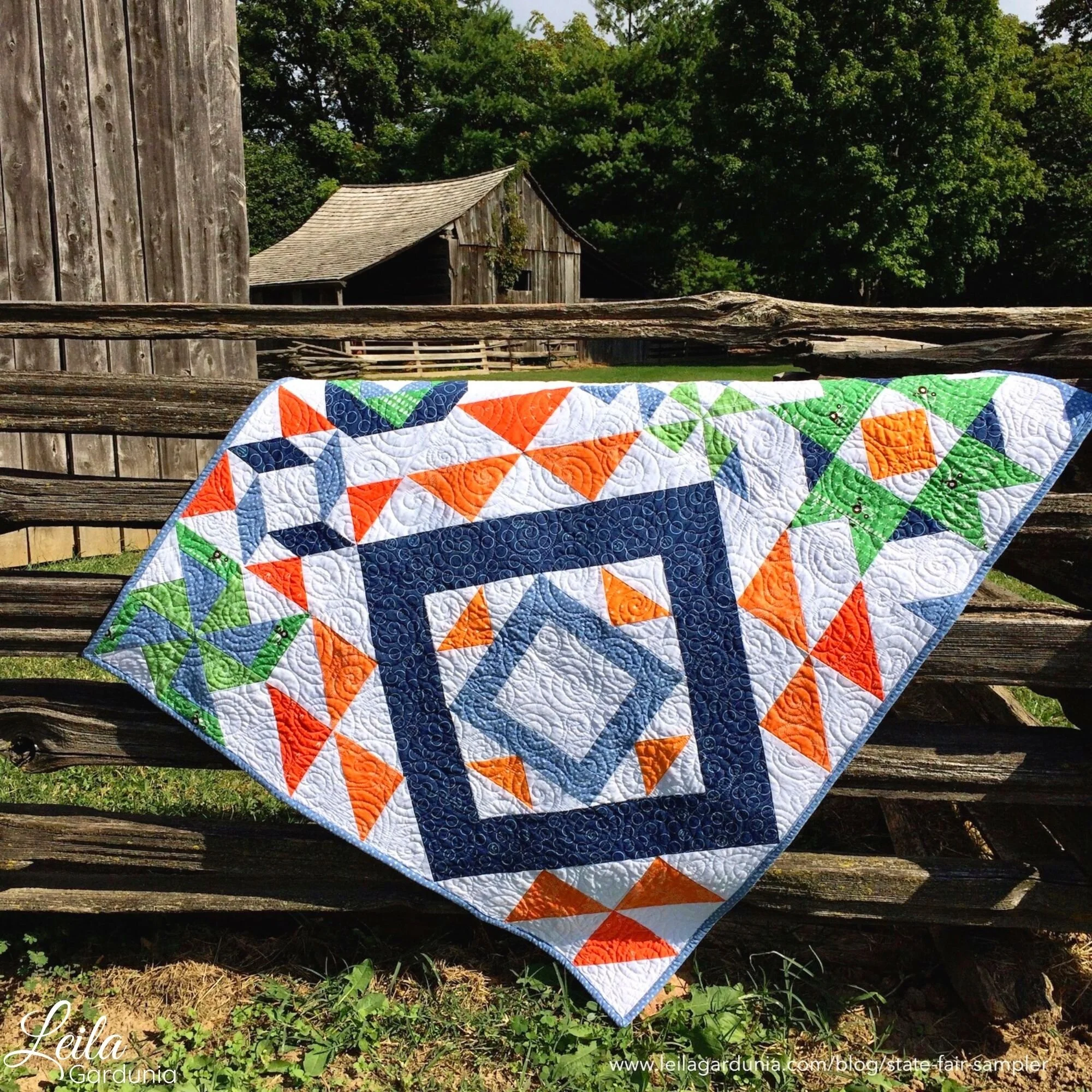 draped state fair sampler quilt orange blue.jpg