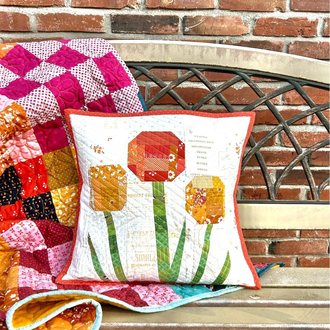 I used a pattern from @auntemsquilts 's new Scrap Quilt book to make this cute pillow! The original pattern used the scrappy improv flowers to make a table runner. It was absolutely adorable too! If you have some scraps you need to use, pick up a cop