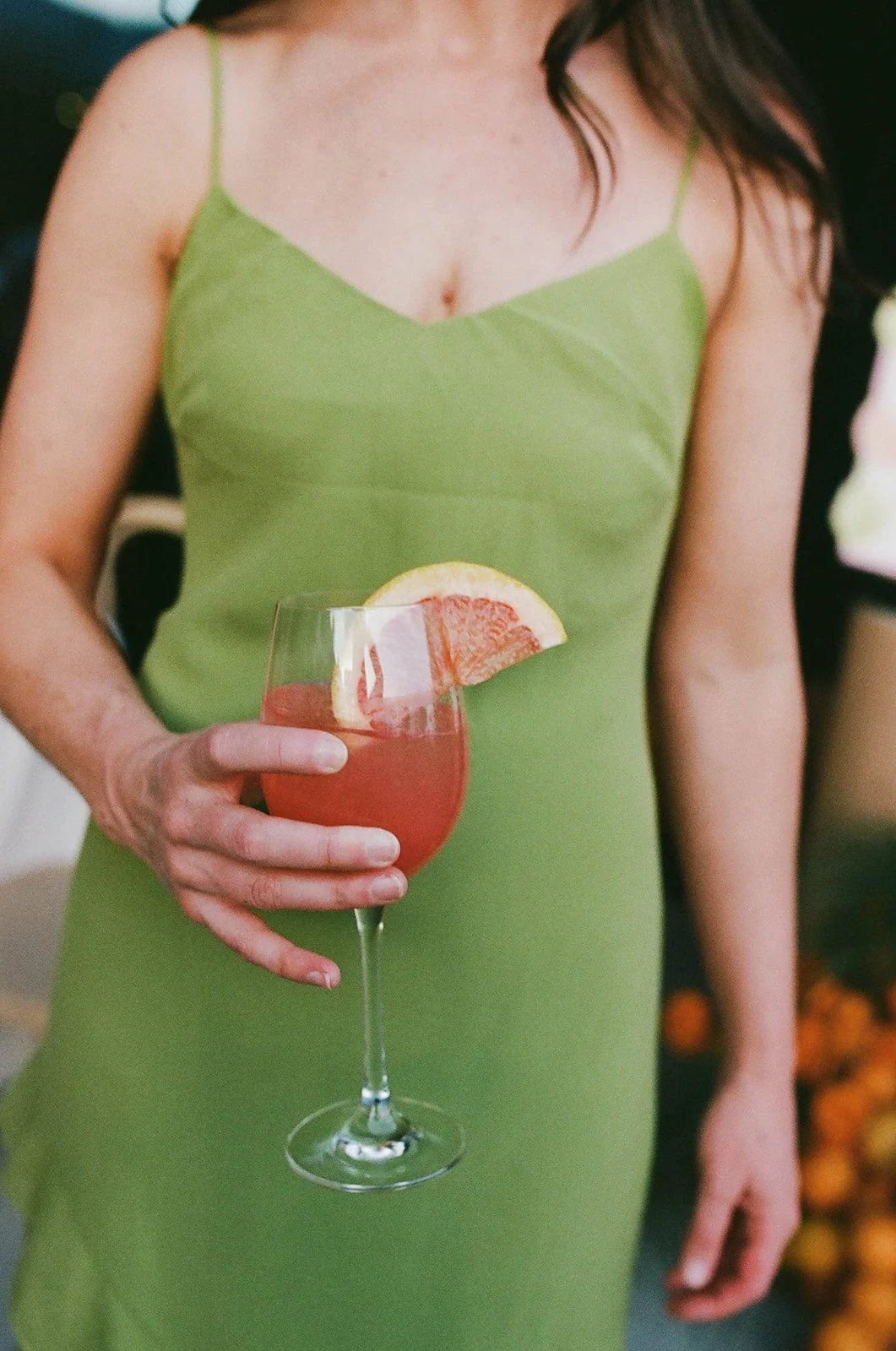 Woman holding cocktail at Palm Springs event with Supermoon DJs.