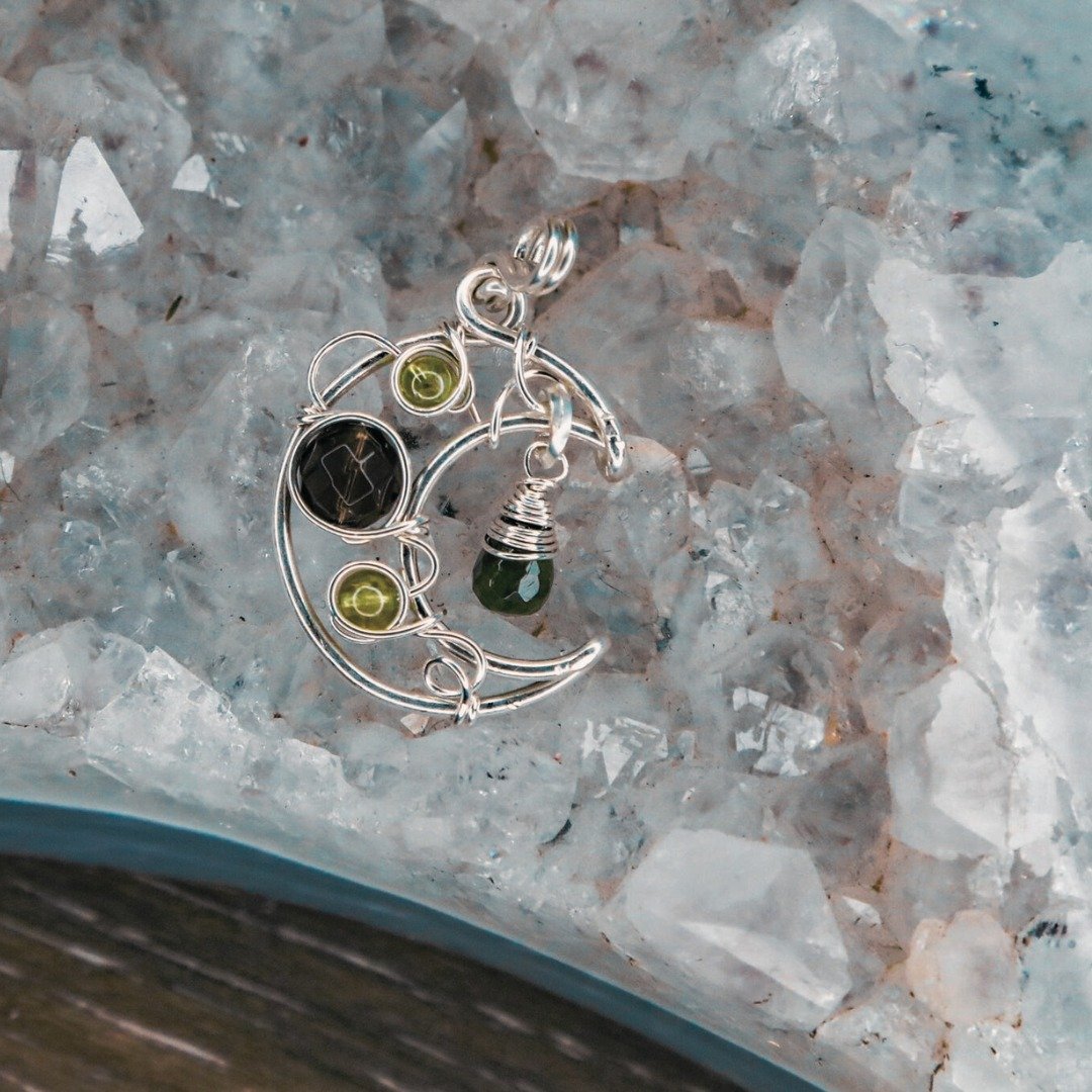 She is a stunner!

Peridot, Smokey Quartz, and Tourmaline are set in a Sterling Silver Crescent Moon Necklace.

Peridot, the &quot;stone of compassion,&quot; graces this necklace with its gentle, heart-centered energy. Radiating love, harmony, and ab