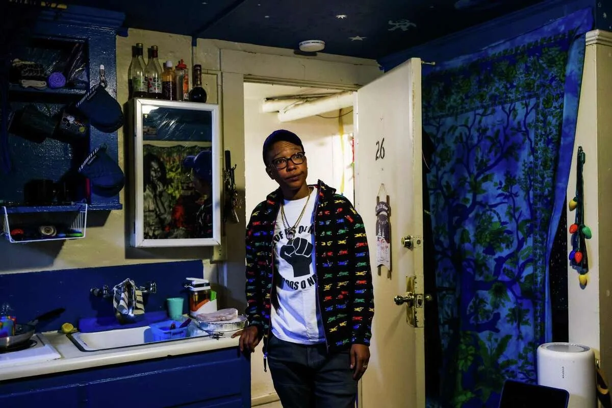 Katie Dixon, 36, stands inside her basement apartment in Oakland.