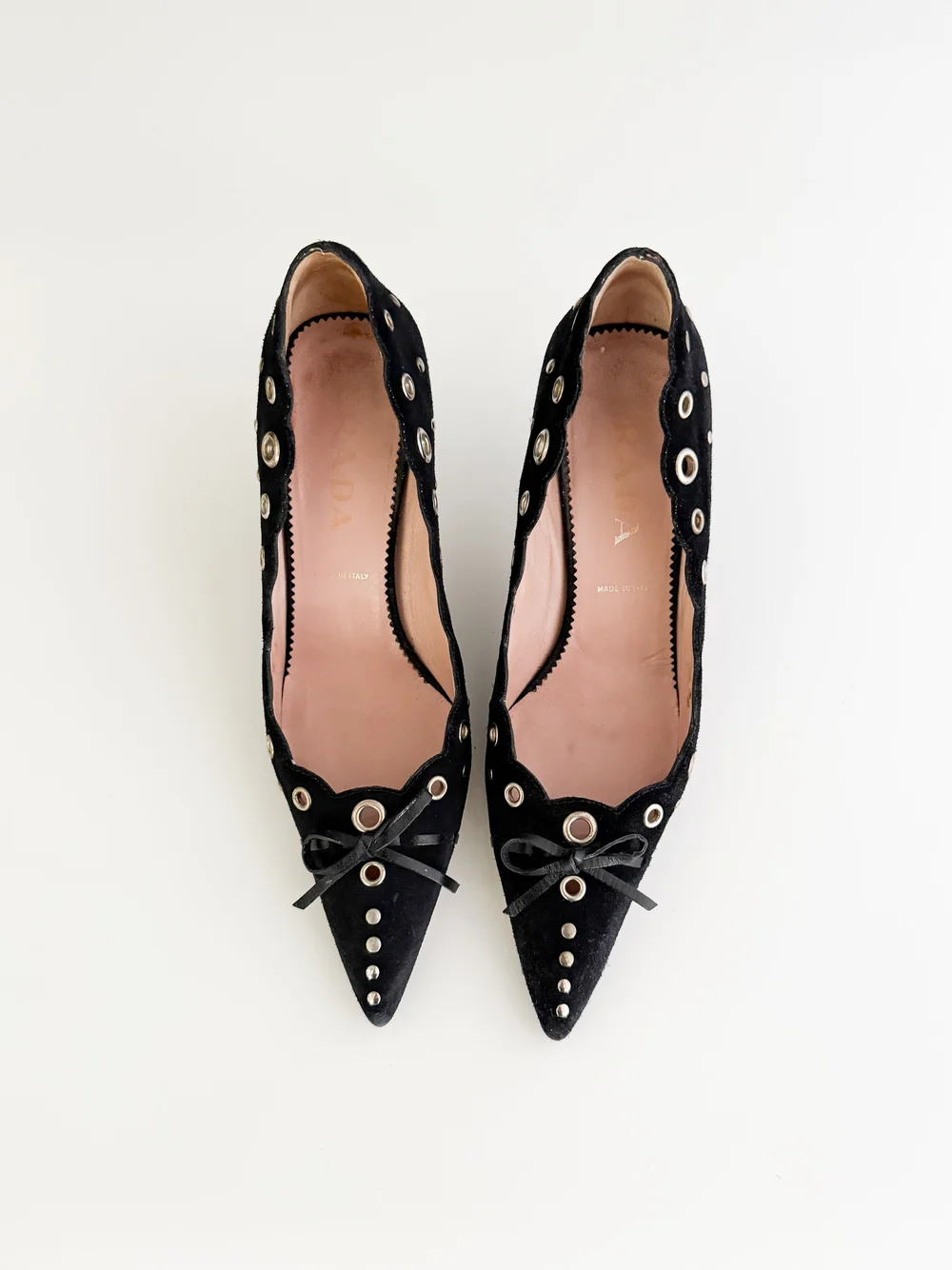 Prada Iconic Black Eyelet Suede Bow Heels (US 7.5 / IT 37) — sororité.