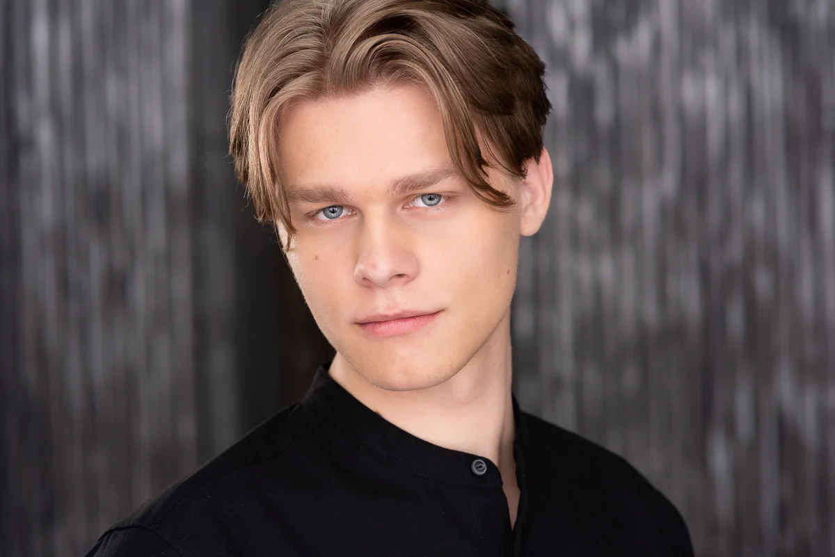 A great headshot with black means matching the tone and only showing a little of the shirt.