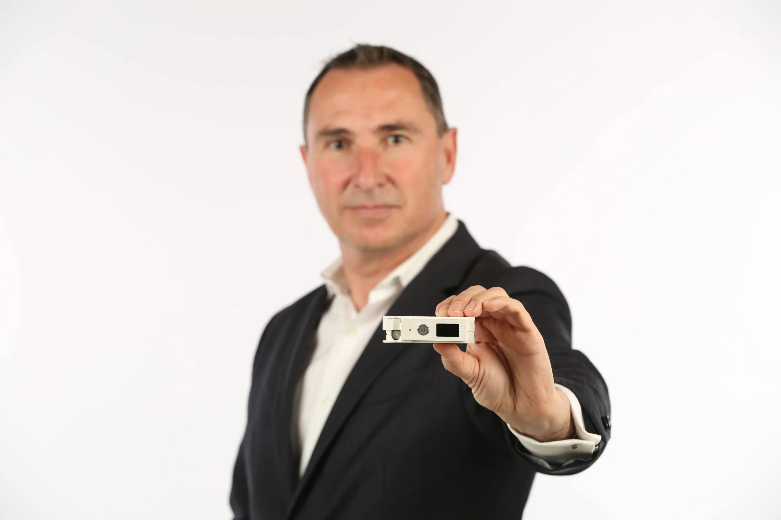 Thar Casey, CEO Amber Solutions with Amber's Premium Solid-State Smart Circuit Breaker.jpg