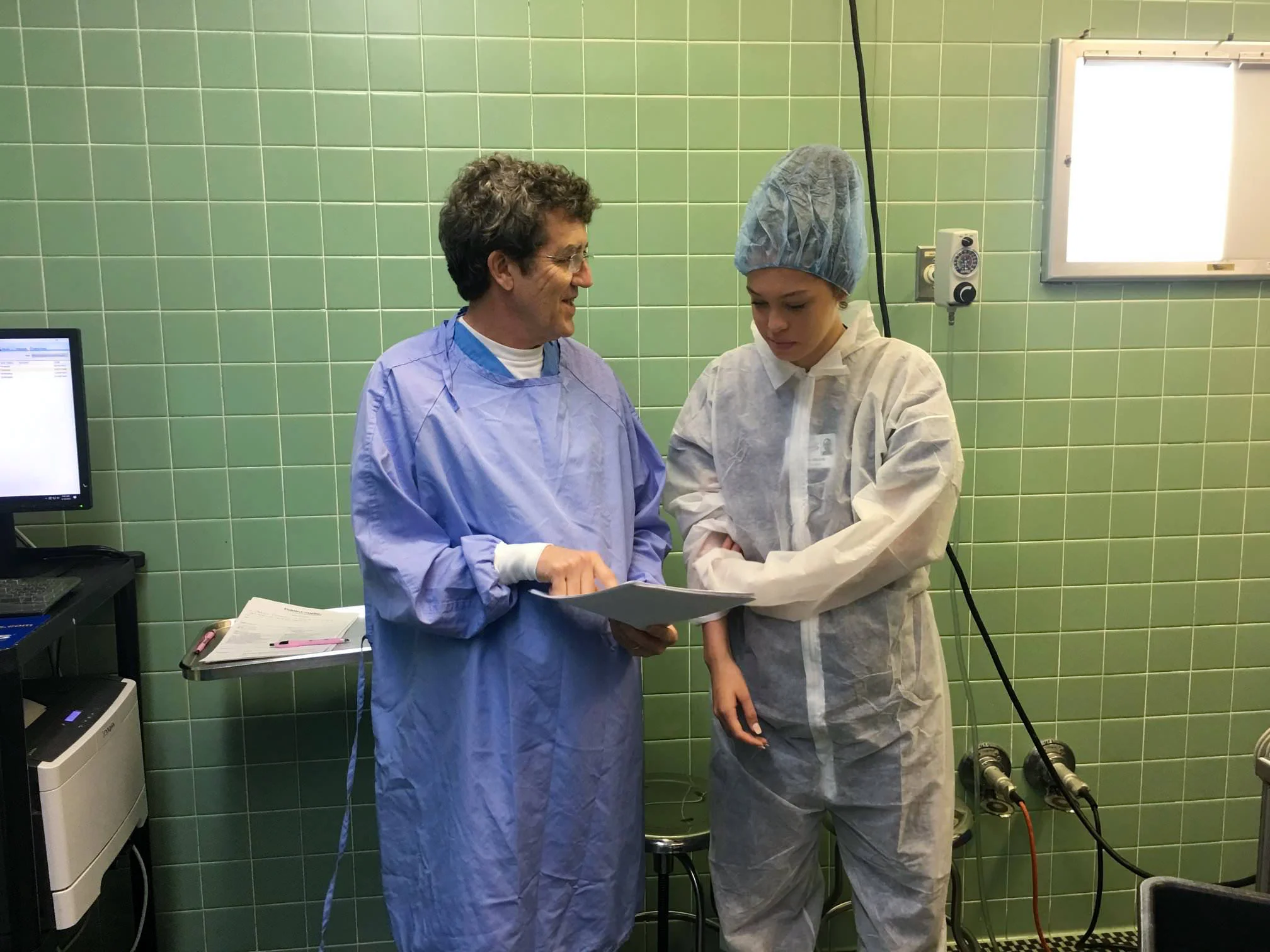 Dr. Doucet goes over operating room procedures with Lauren Webre (CHSPC).