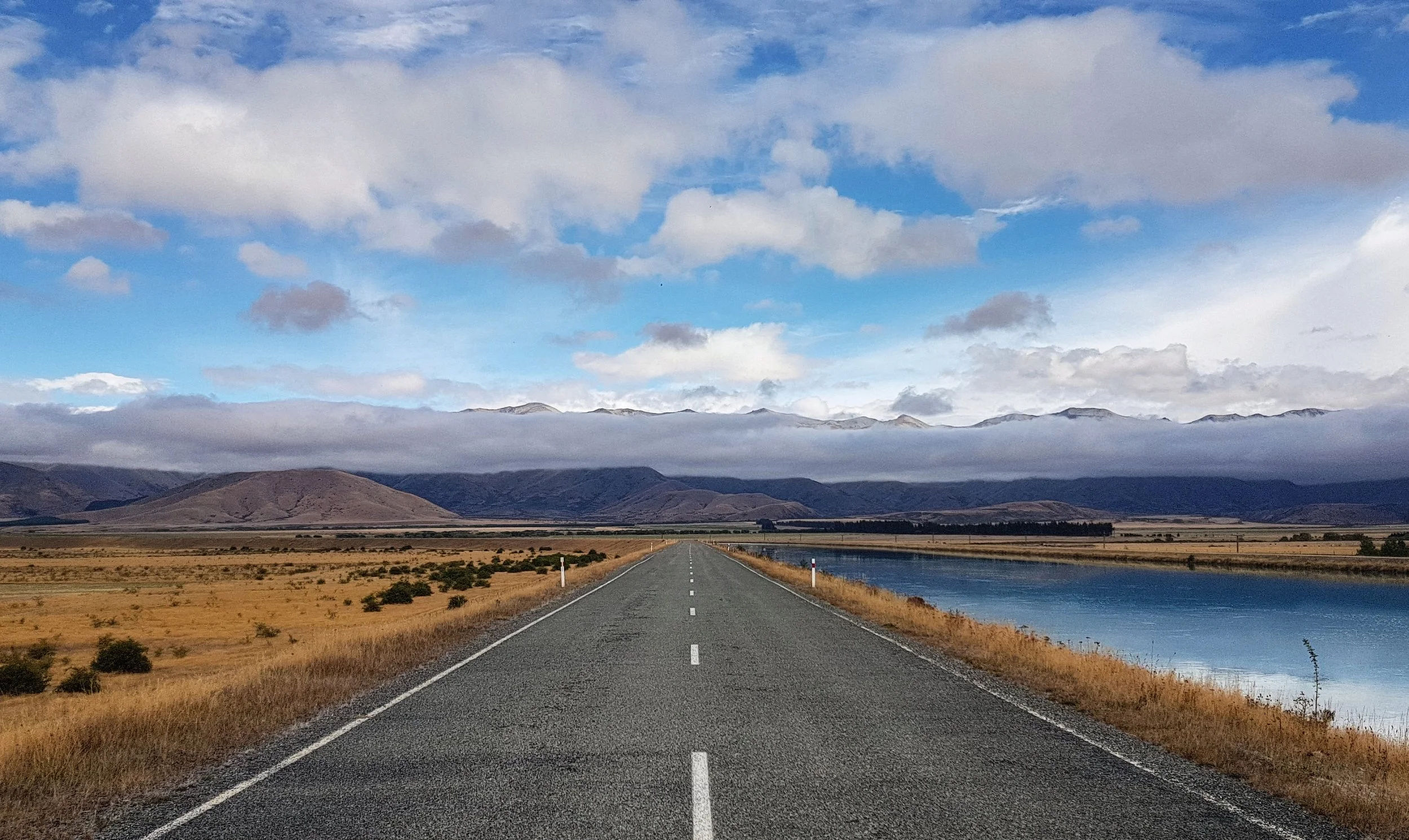 The views as you head from Lake Pukaki to Highland Escape with the Ben Ohau Range behind the clouds