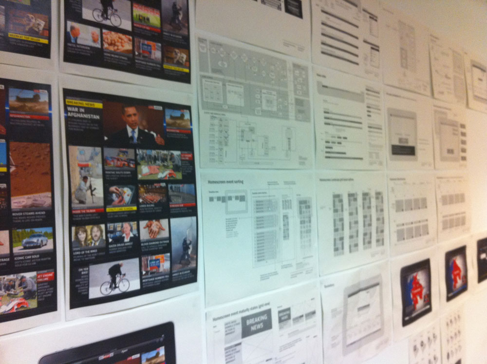 A selection of system diagrams, journeys and UI designs on our war room walls