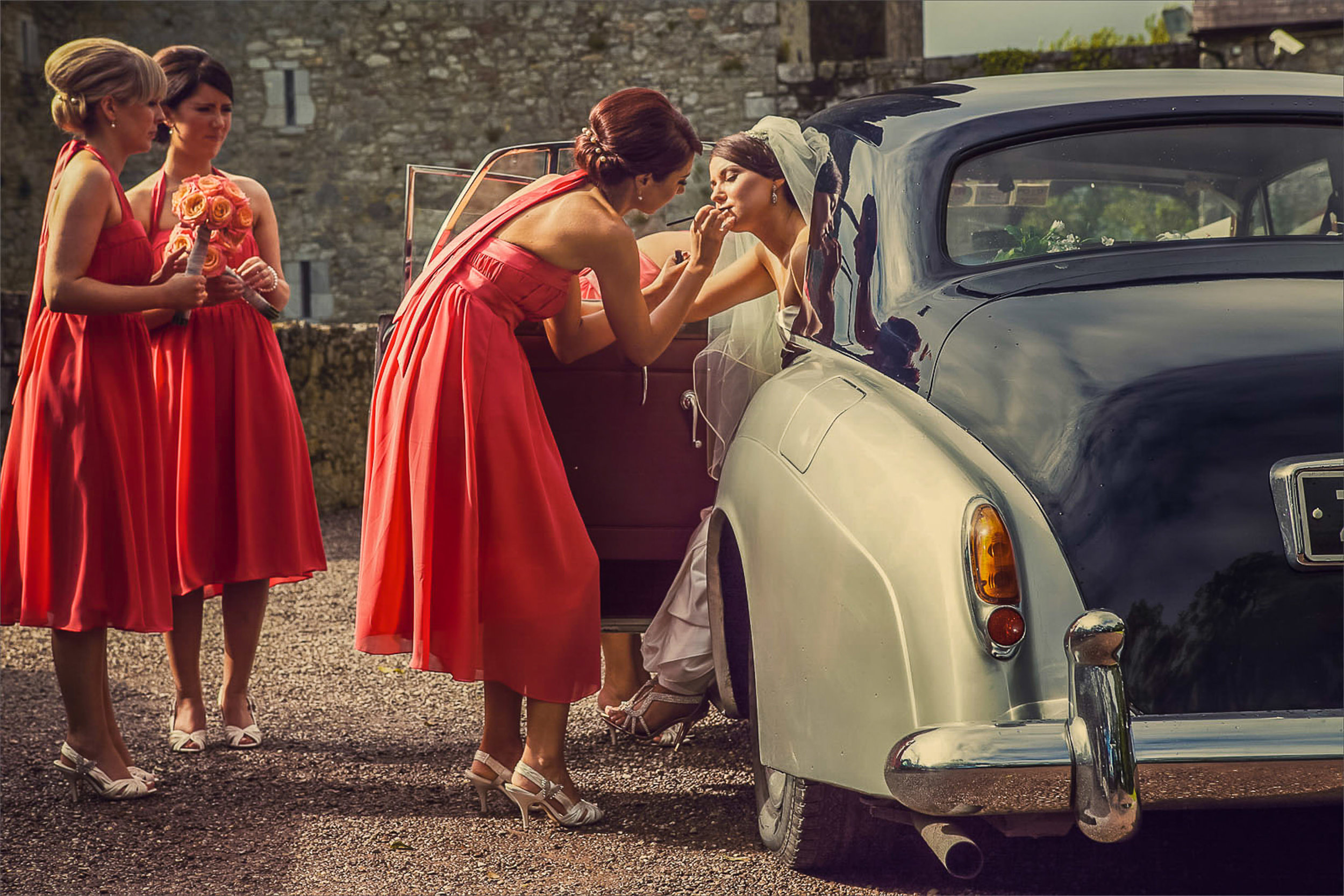 Vintage Wedding Car - Wedding photography in Cork Ireland by David Casey. Bride in white wedding dress with bridesmaids in colourful bridesmaids dresses