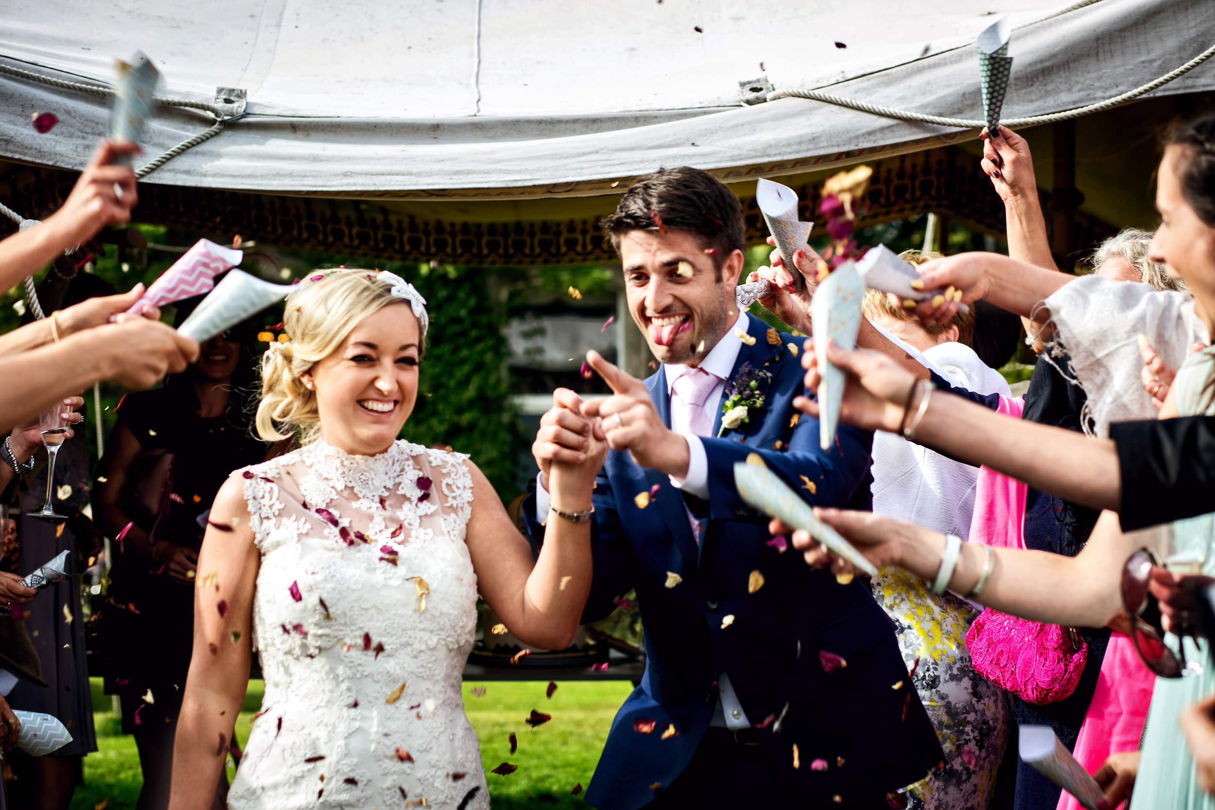 Ballyvolane House Wedding Photos by Cork and Kerry wedding photographer David Casey. Bride and Groom fun photos. Bride in White wedding dress and groom in navy suit with mint tie. Confetti photo