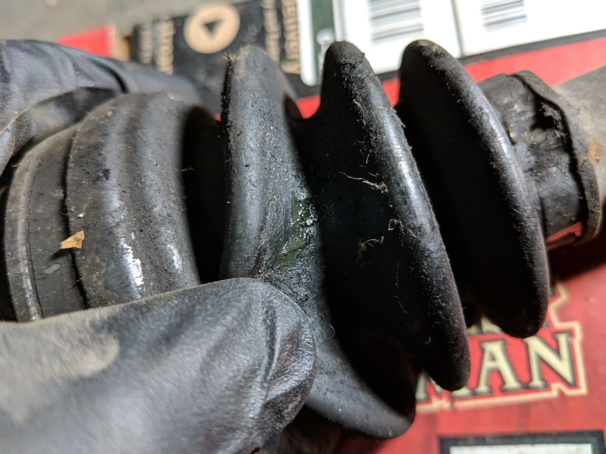 Small tear in the boot and leaking grease.