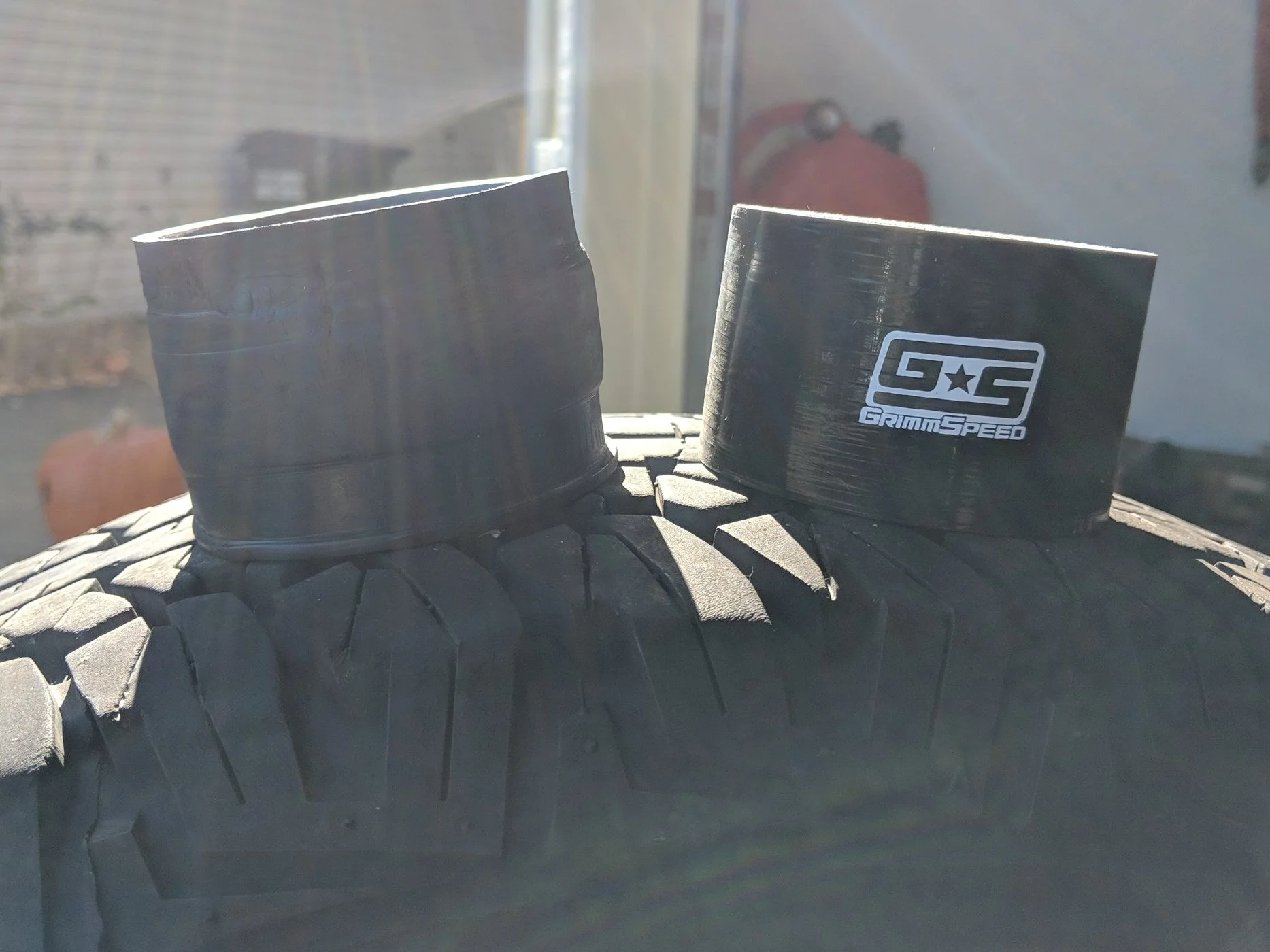 Stock throttle body unit on the left and upgraded silicone Grimmspeed unit.
