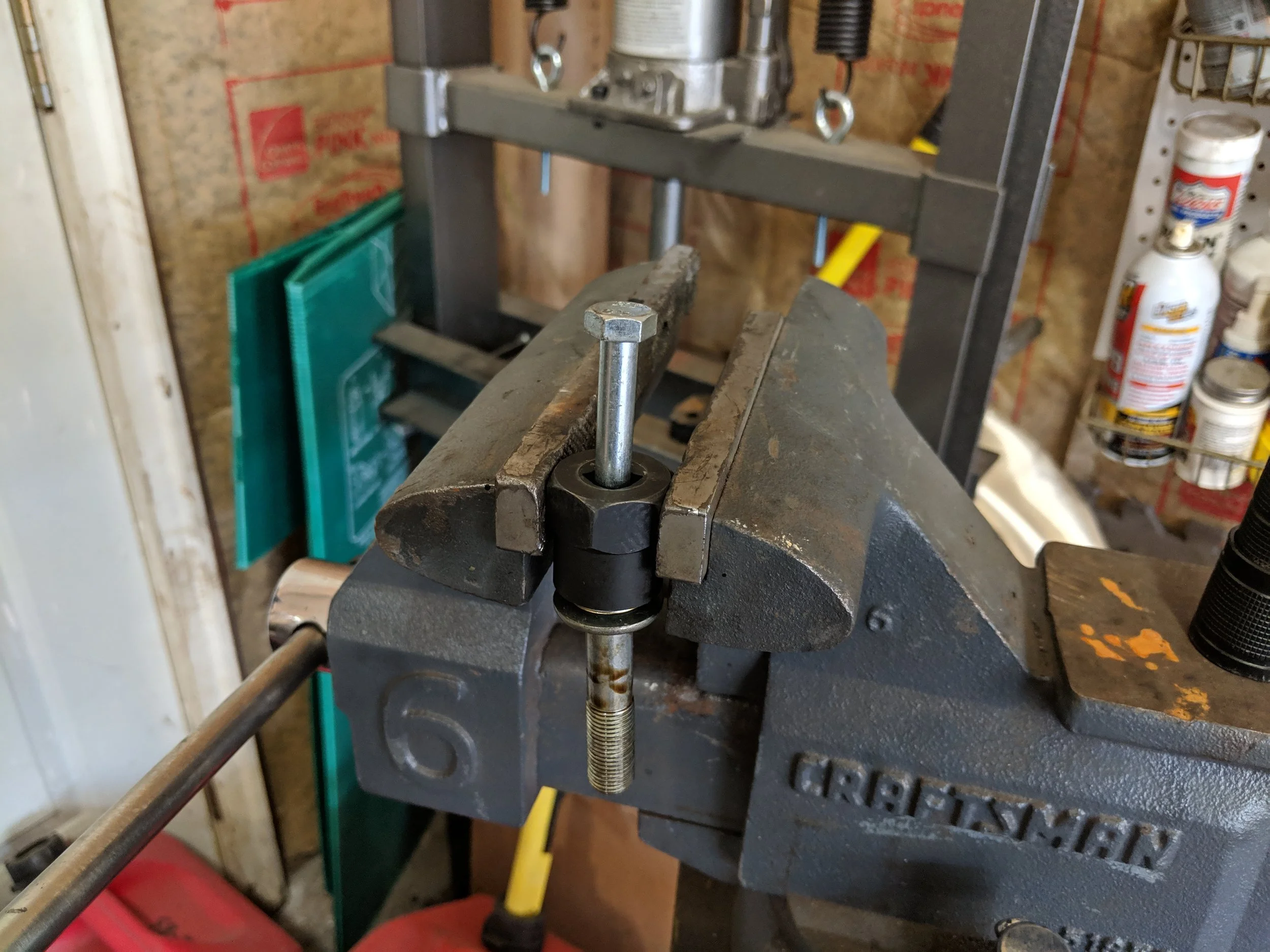 Using a punch or smaller bolt you don’t care about. You can knock these things right.