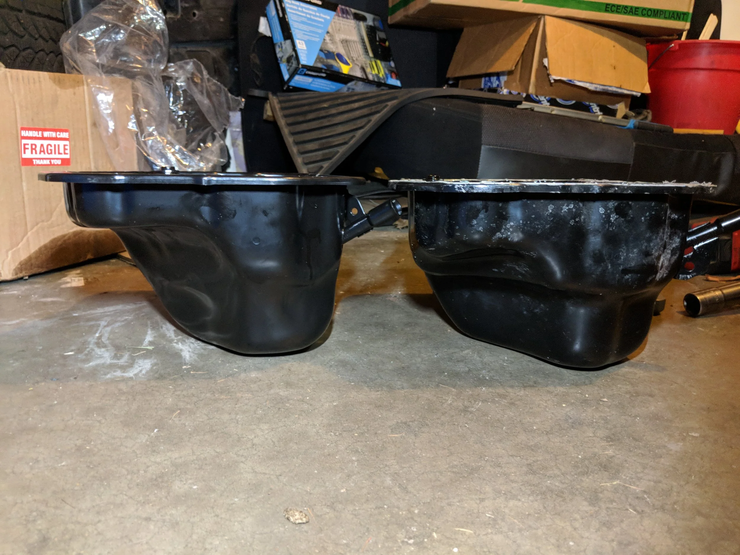 06+ STI oil pan on the left and 04-05 STi pan on the right. The lower protrusion on the left side cause the MAPerformance header to be unable to be fitted.