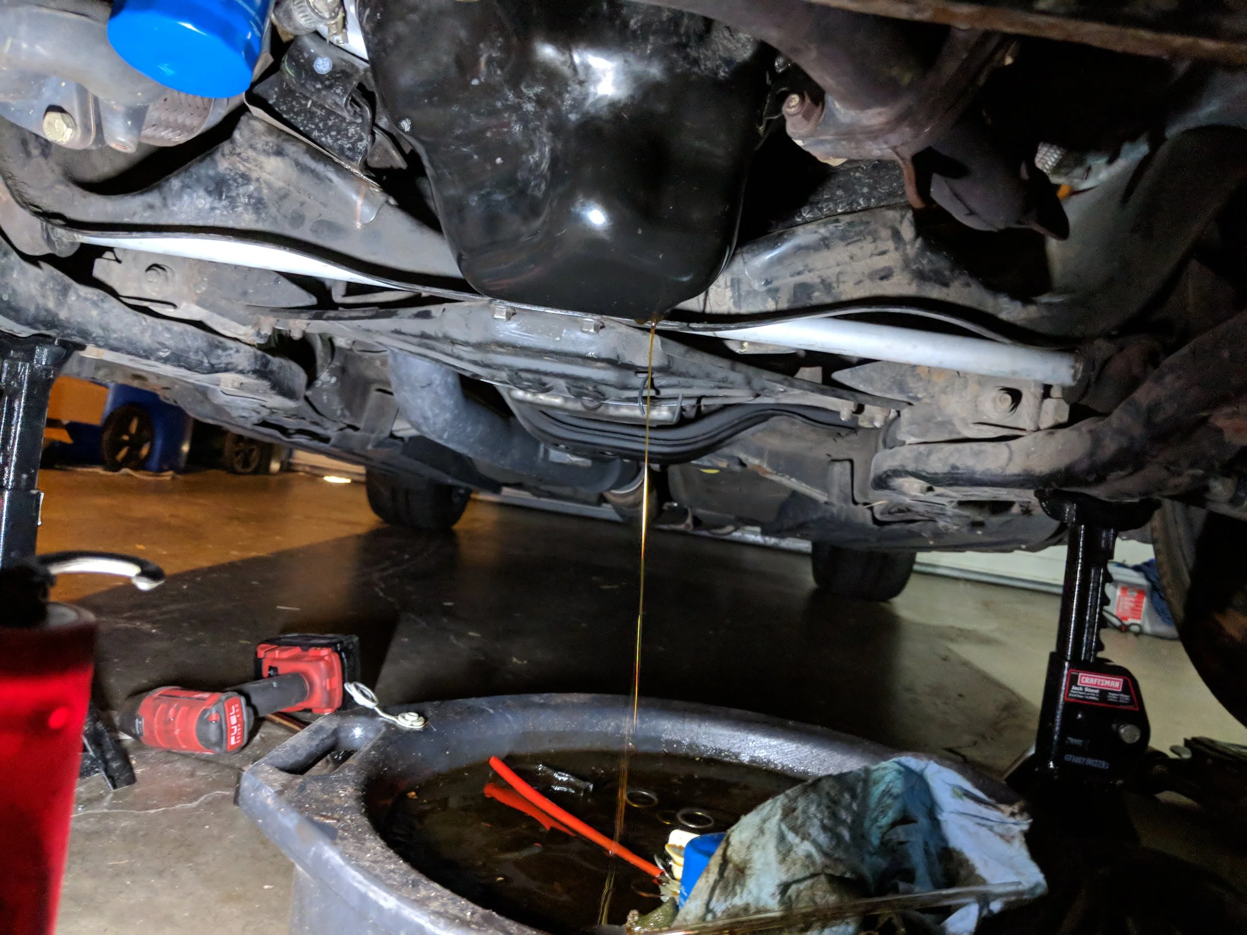 Up on jack stands and getting the oil out of the pan.